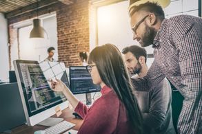 Website designer working on programming and coding in an office.