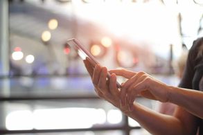 Close up of a woman's hands holding a smartphone.